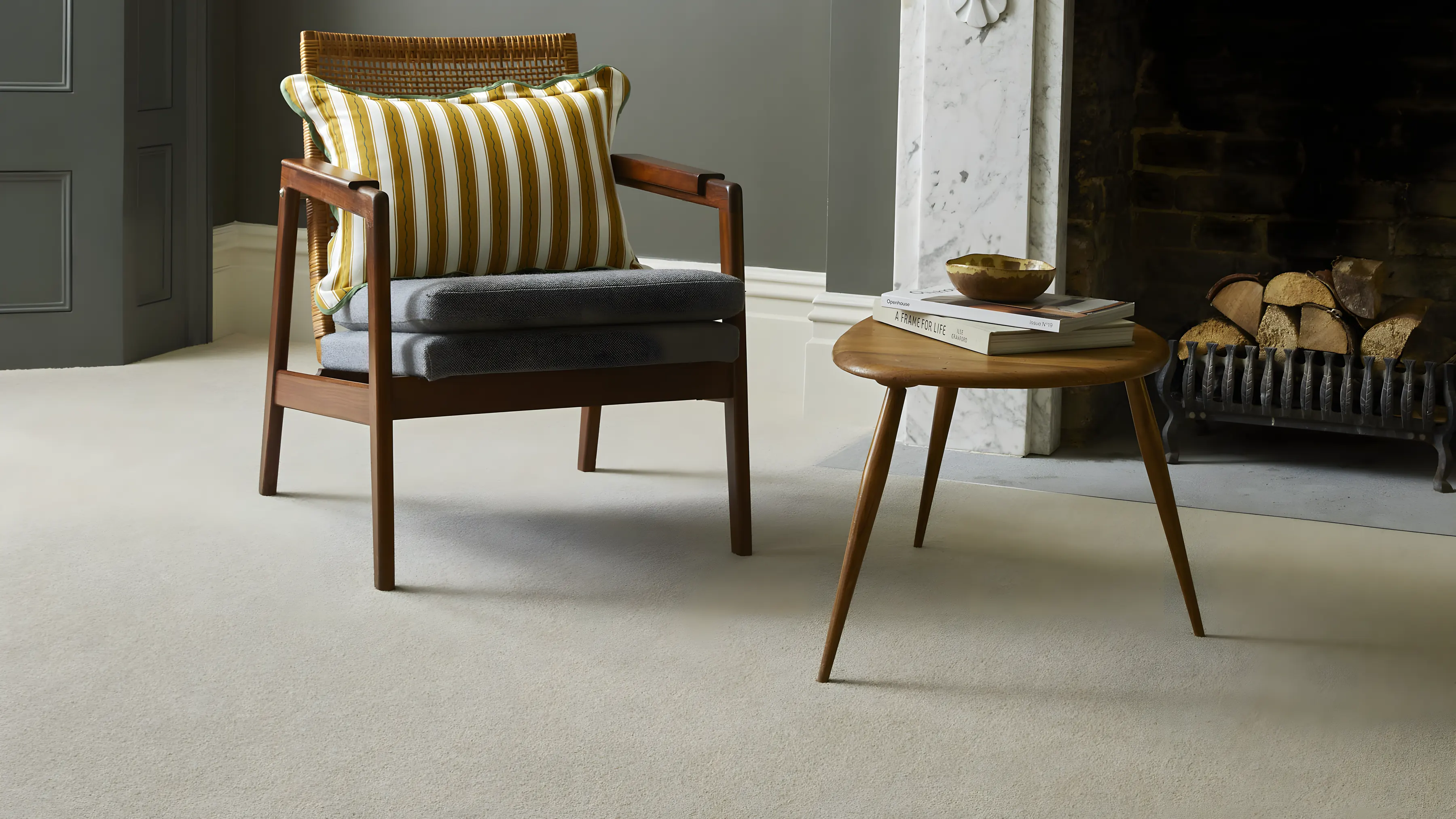 A grey sitting room with a fireplace and a grey wool carpet