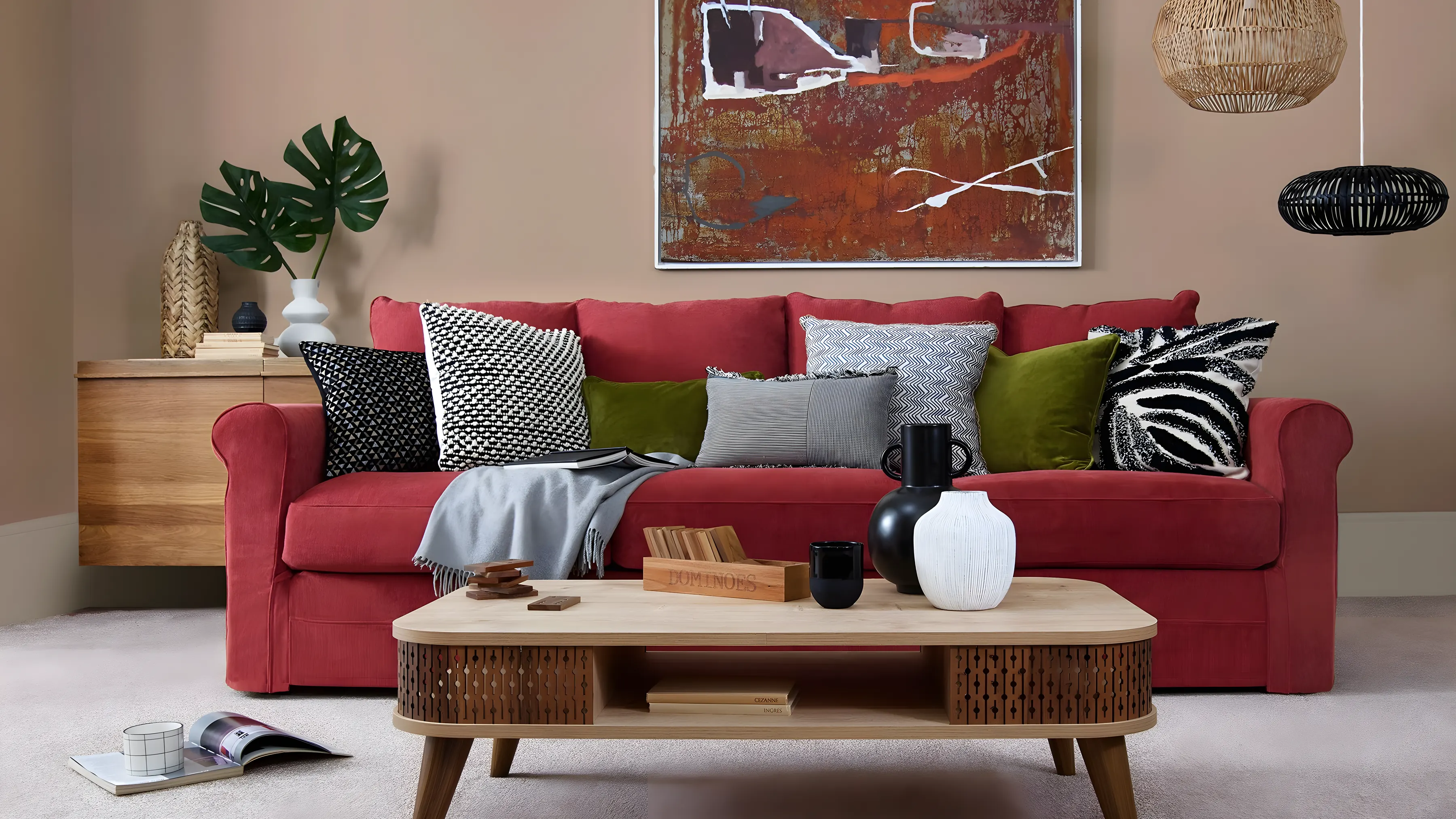A red sofa on a pale flecked carpet in a bright living room