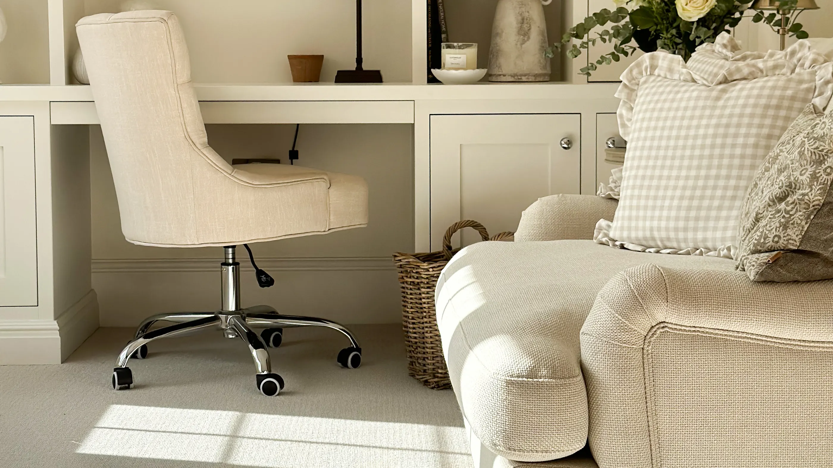 A white study with a striped carpet and a cream armchair