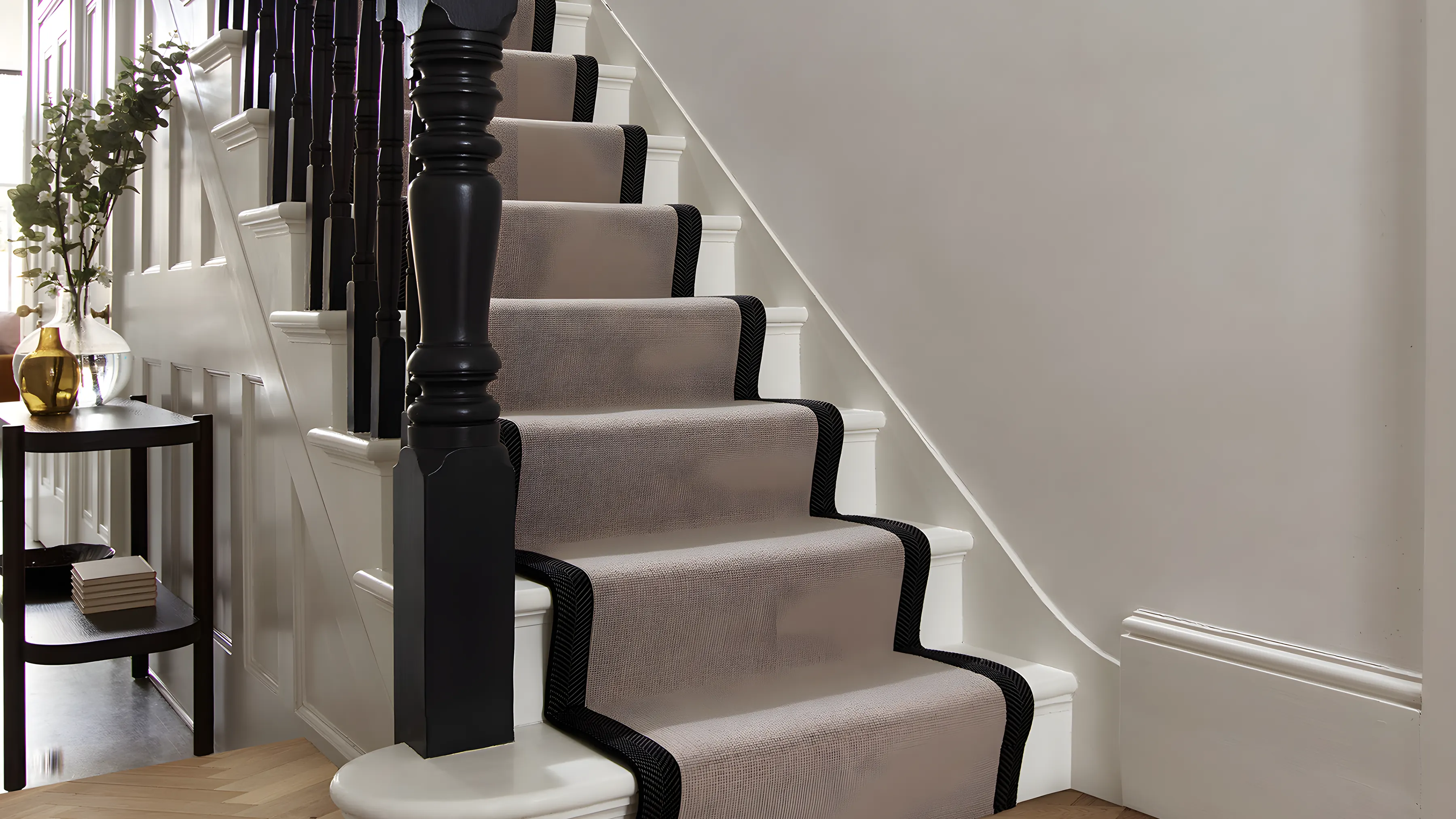 A striped runner on a painted staircase above a herringbone floor