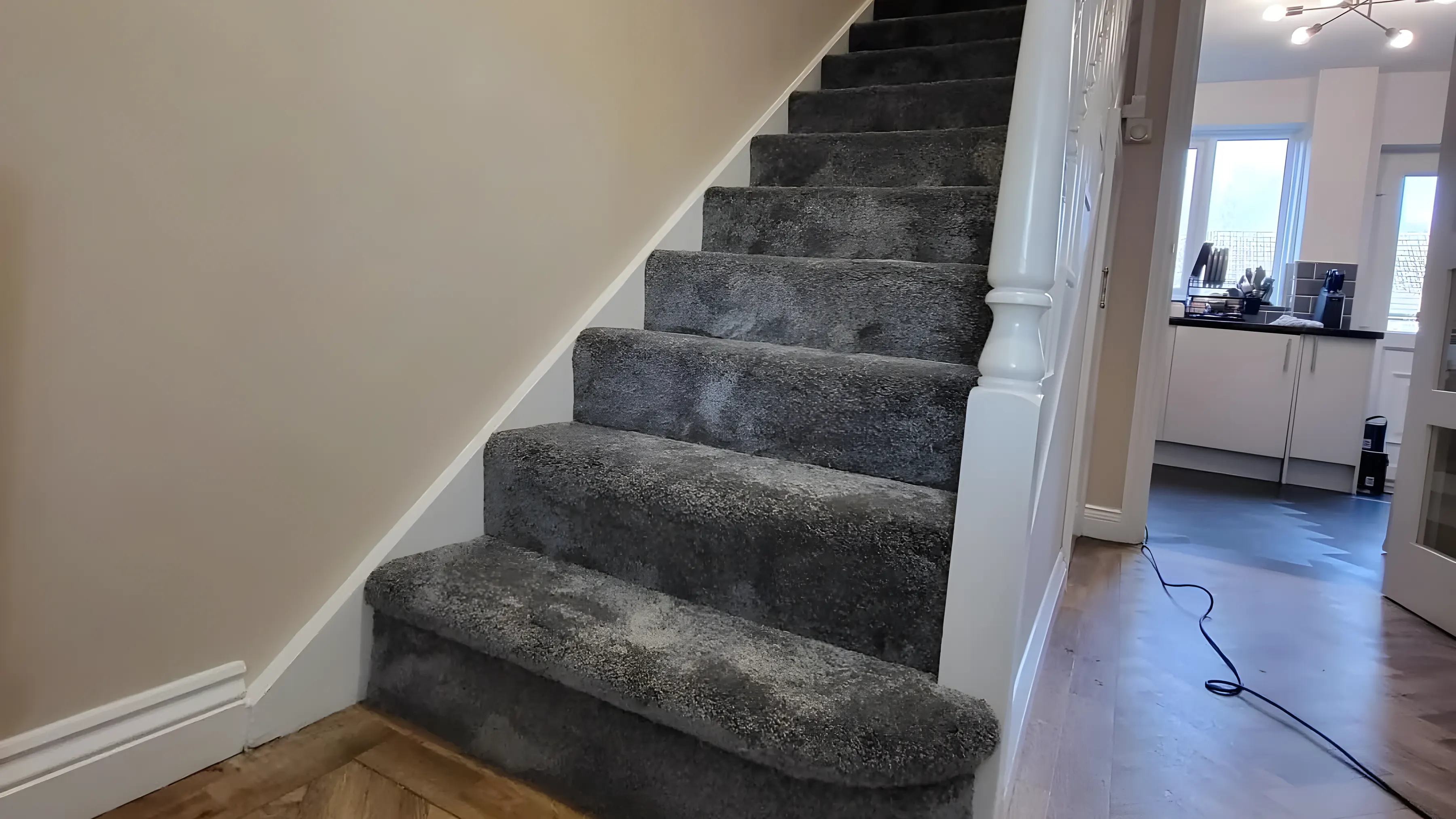 A grey stair carpet fitted by Park Flooring, cut and folded around each step