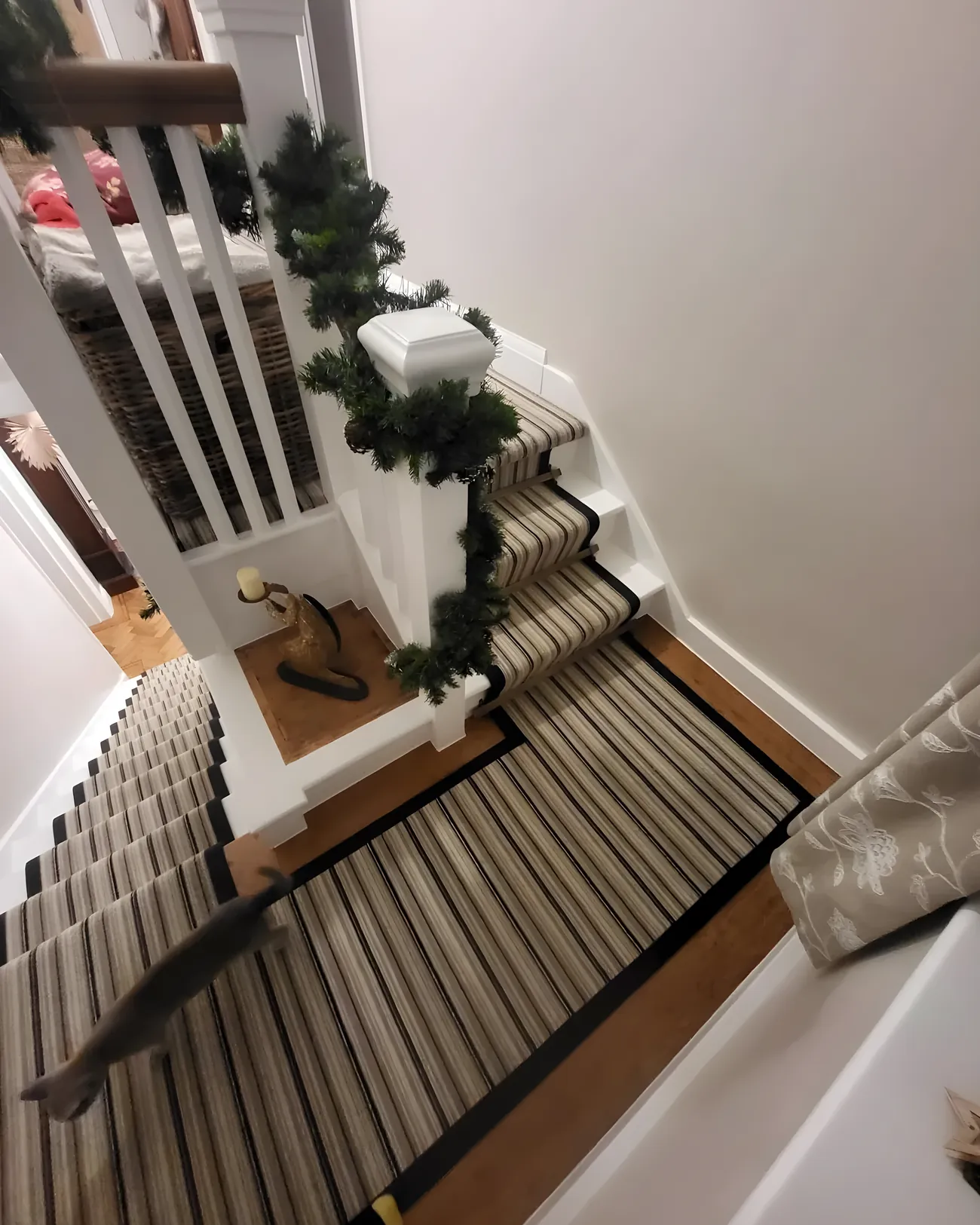 A striped stair runner fitted by Park Flooring, seen from the landing