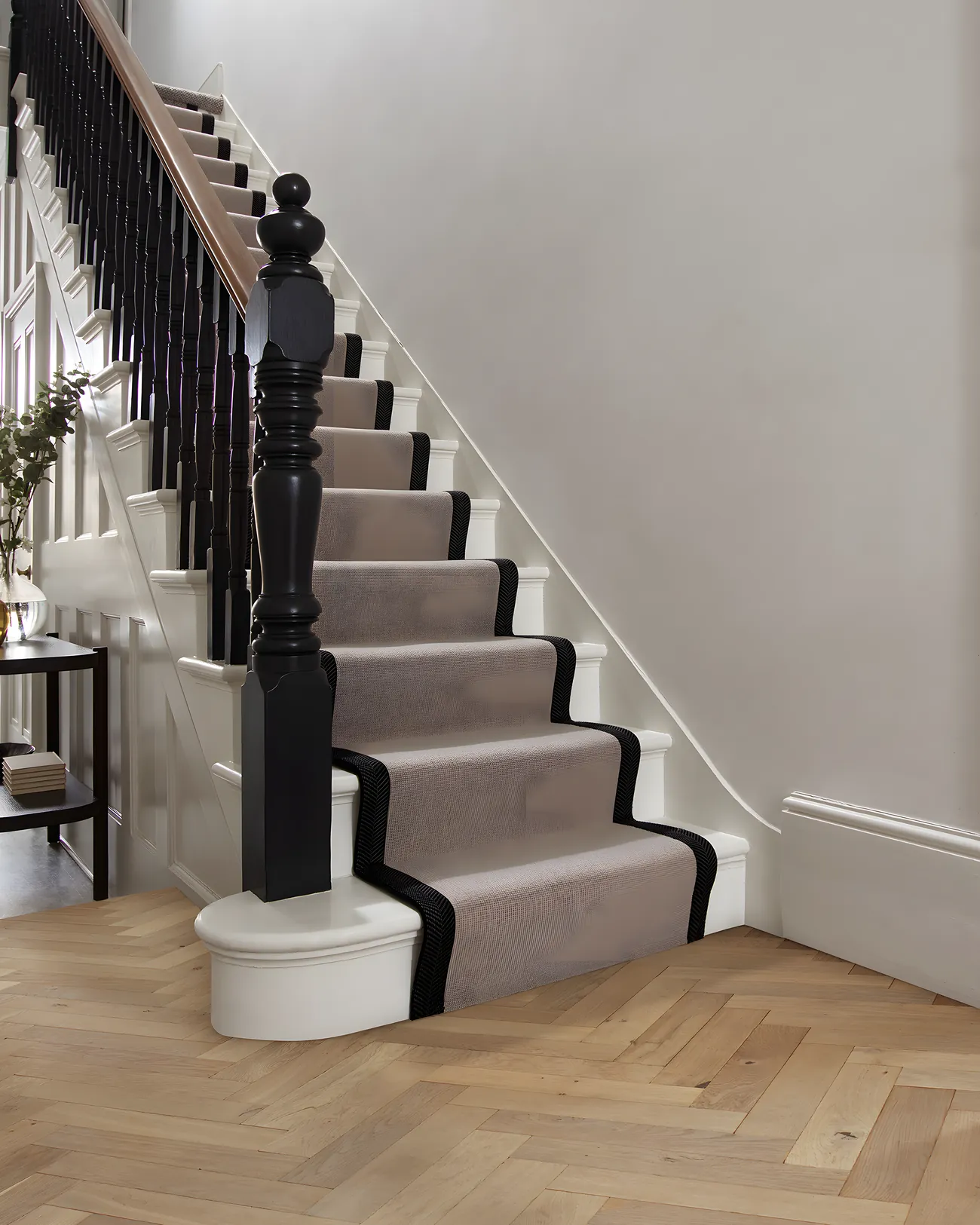 A striped runner on a painted staircase