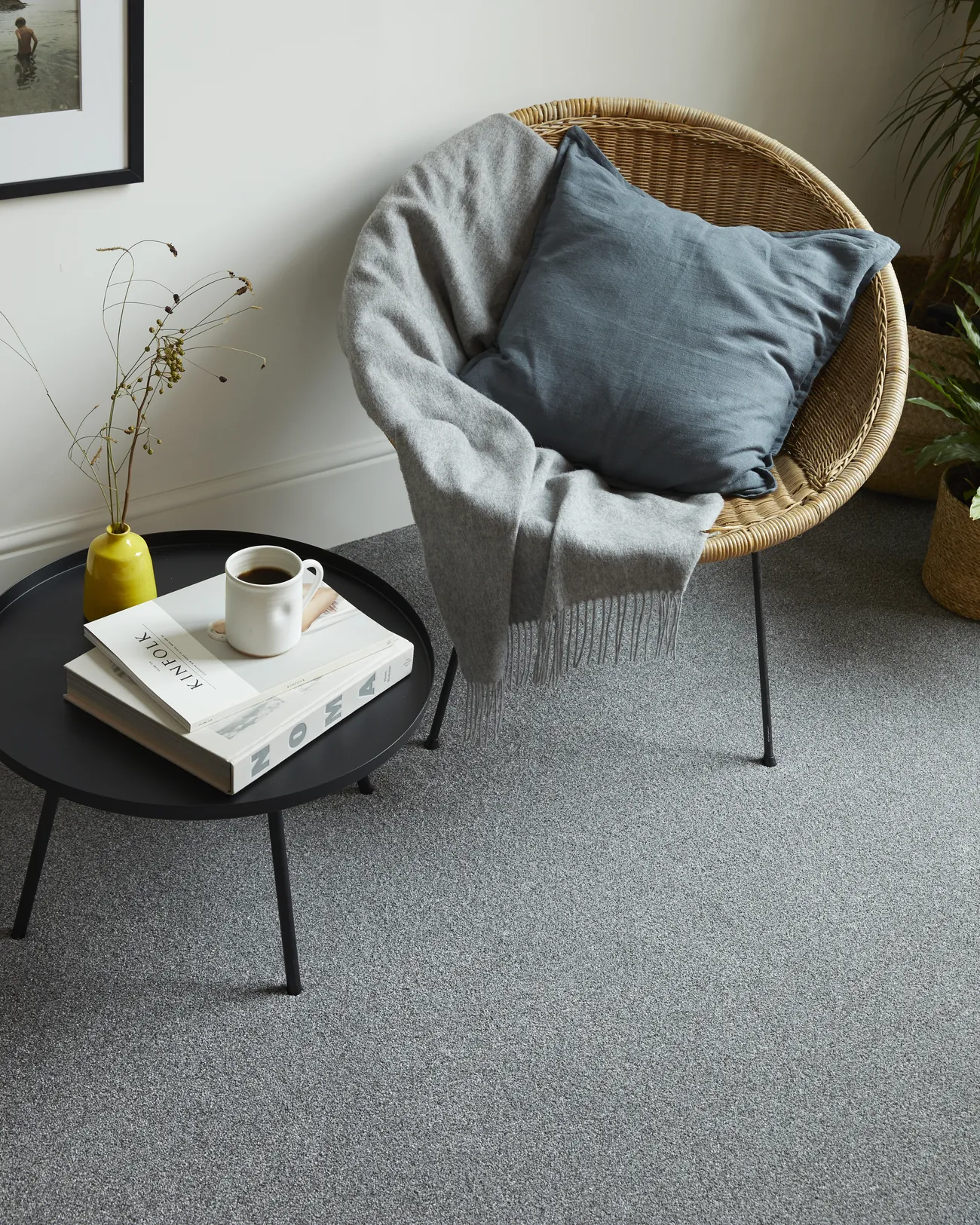 A rattan chair on a grey carpet