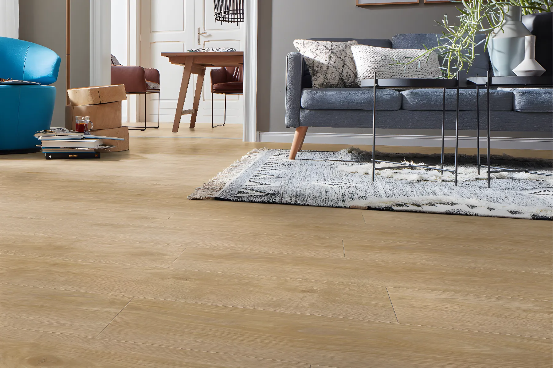 Pale oak laminate in a living room with a grey sofa