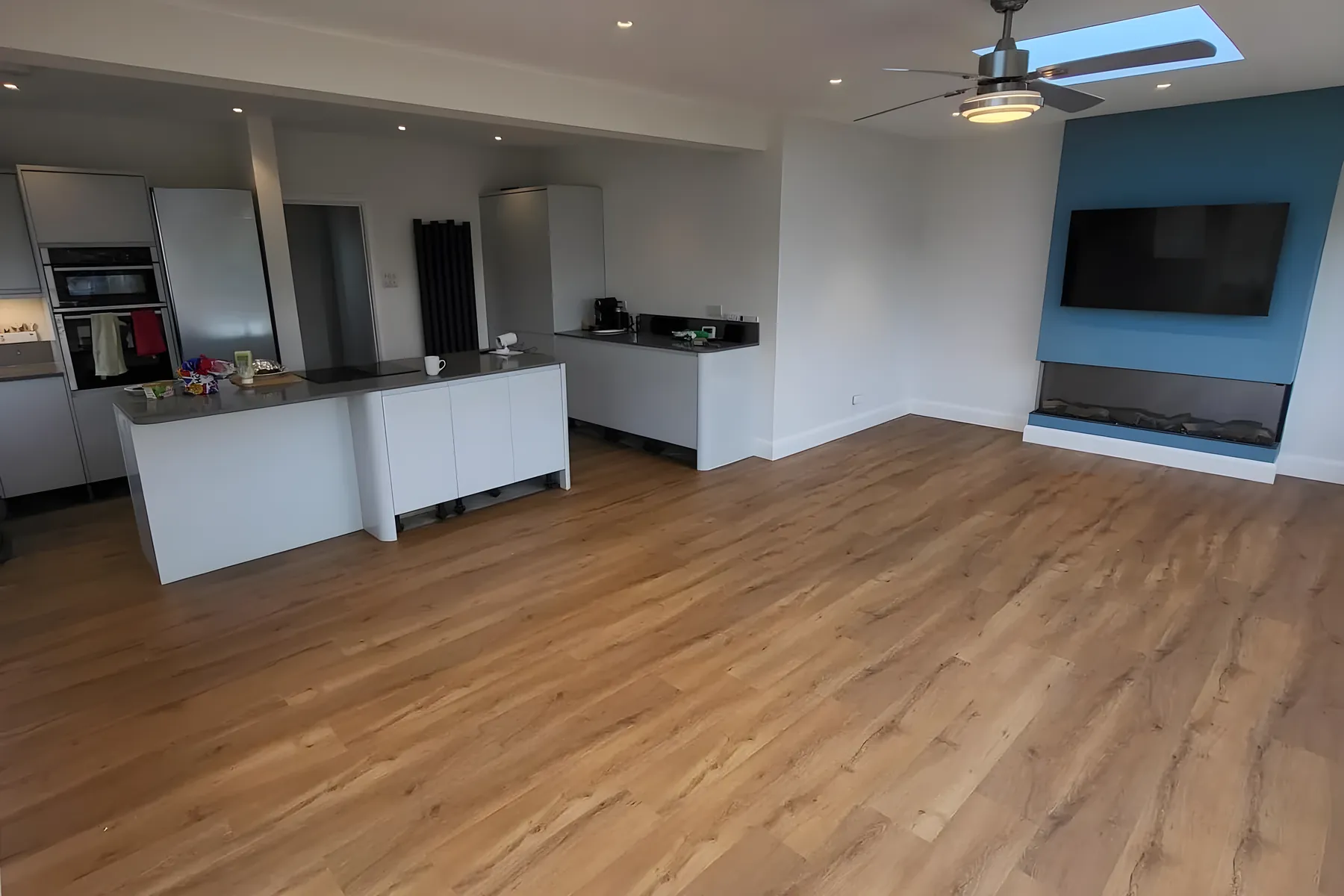 A kitchen and living room finished in oak effect luxury vinyl tile by Park Flooring