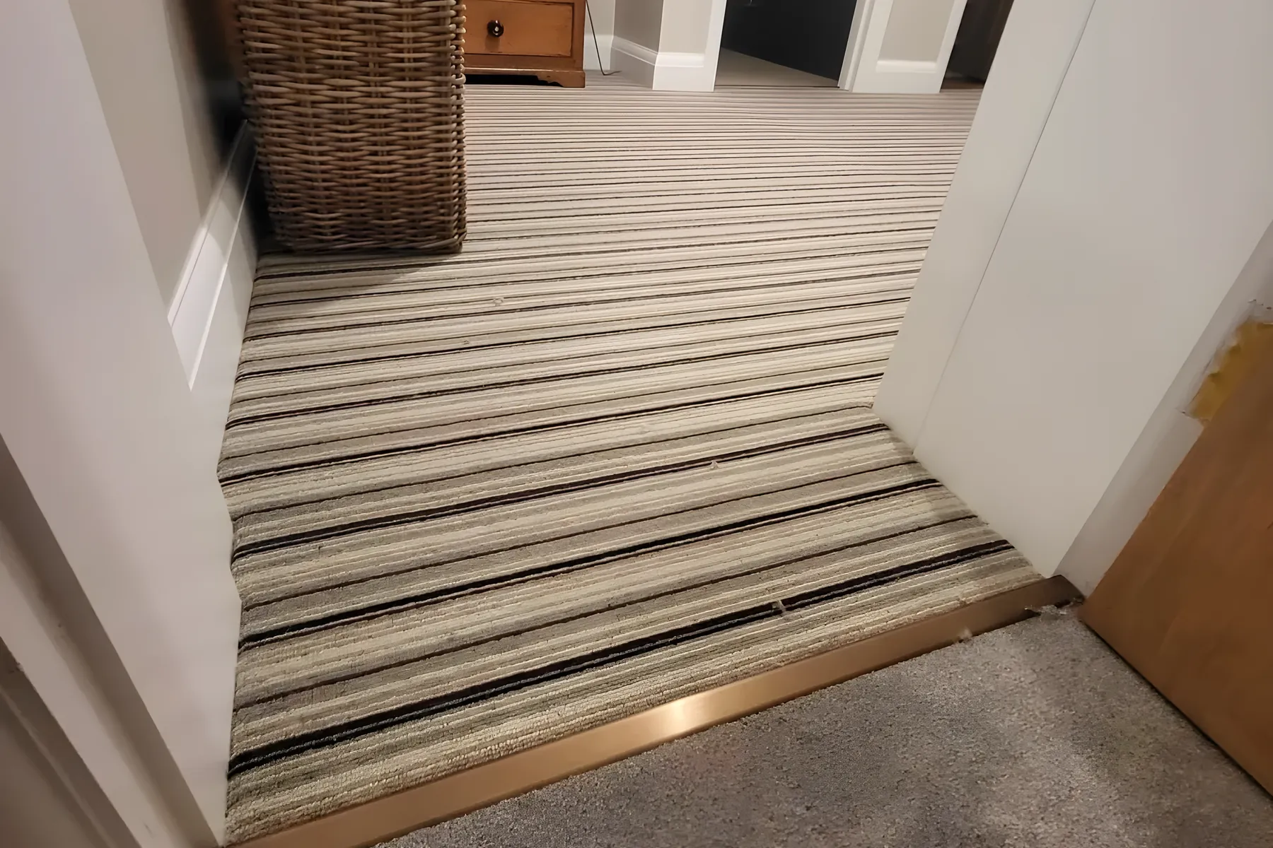 A striped runner fitted by Park Flooring at the foot of a flight