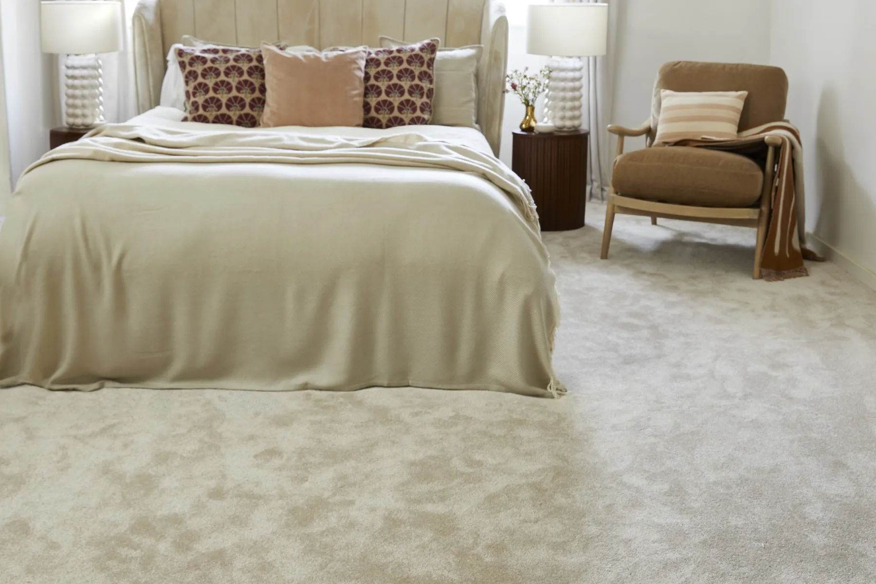 A calm bedroom with a deep pile cream carpet